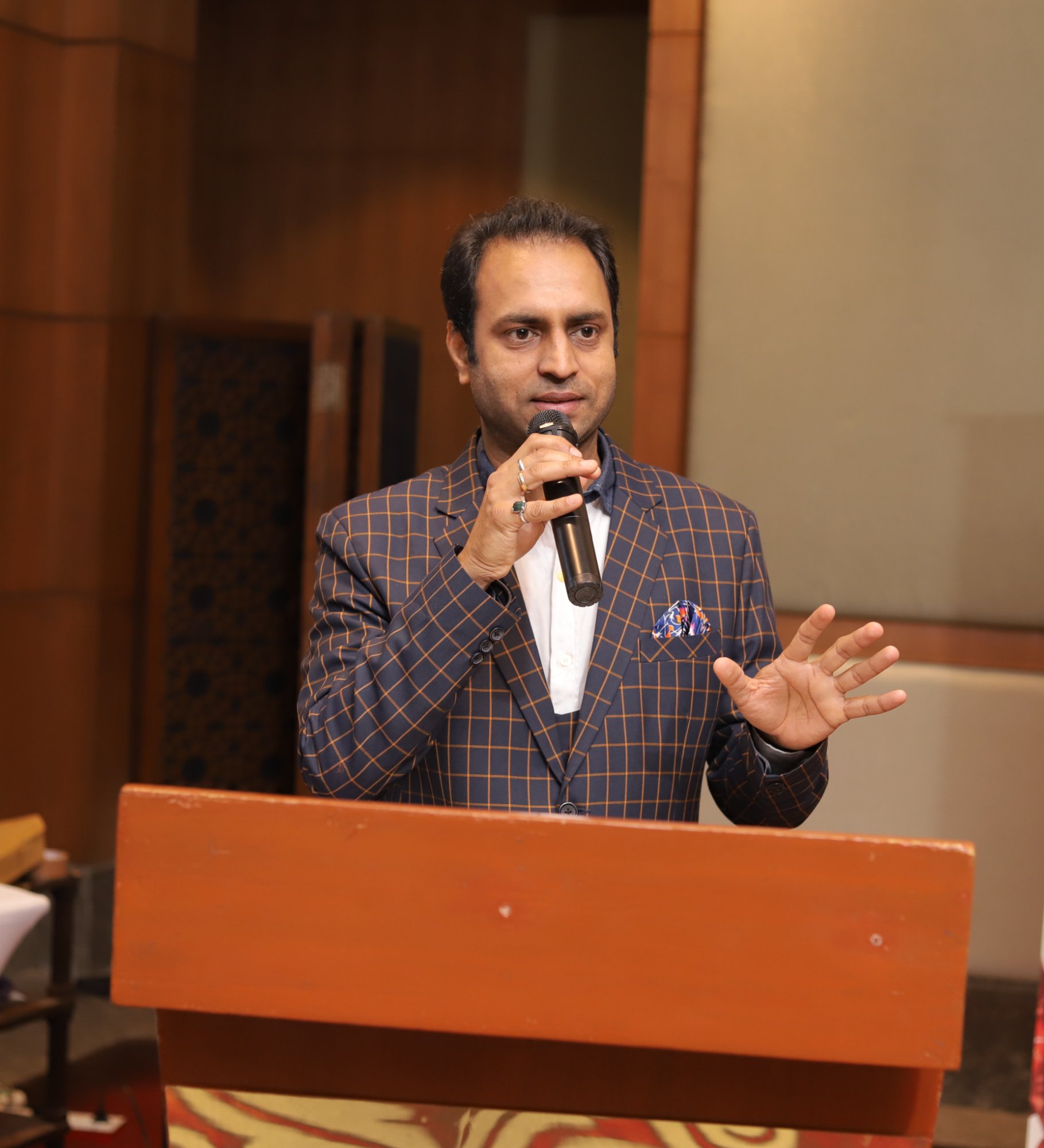 Rajdeep Singh Chauhan speaking at a lectern